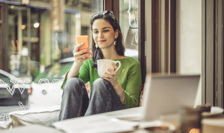 Best BYOD security practices for mobile, Woman looking at mobile device while working in a coffee shop